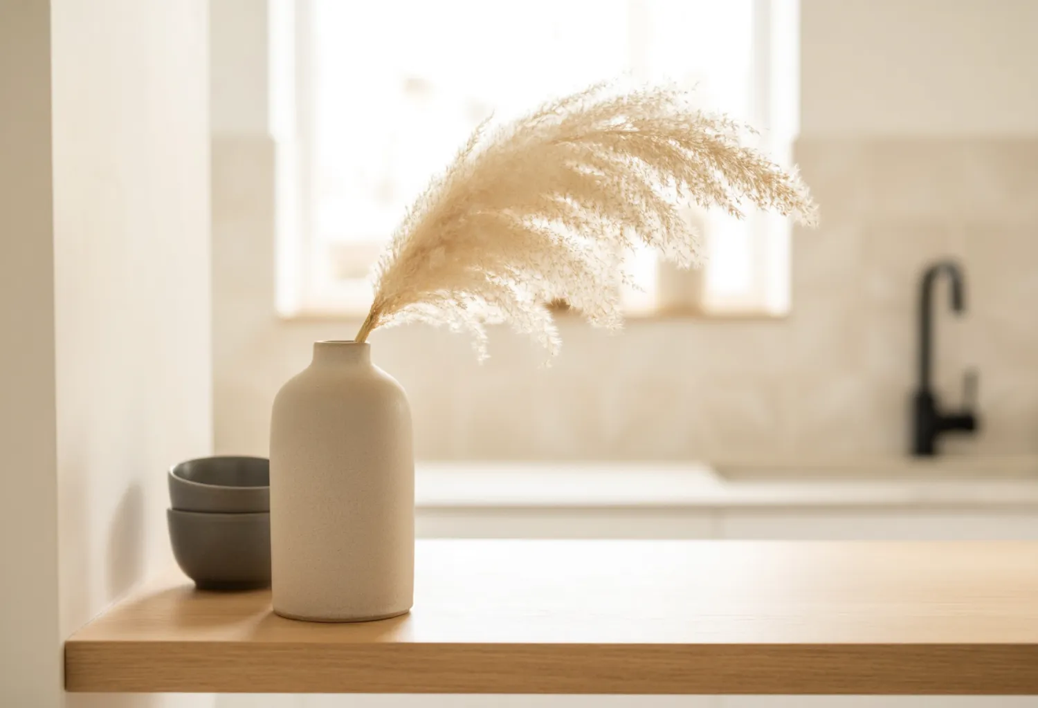 Use dried florals or pampas grass in a stoneware vase